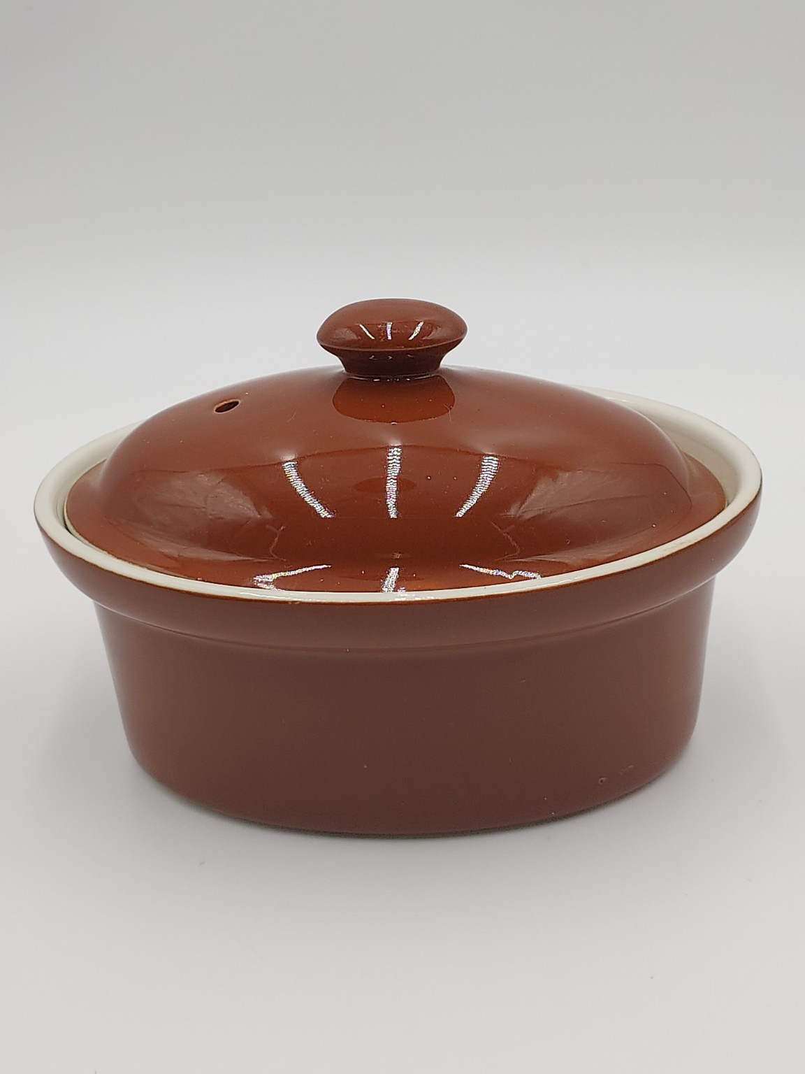 Brown glazed covered pottery dish